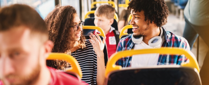 People chatting while riding a shuttle bus